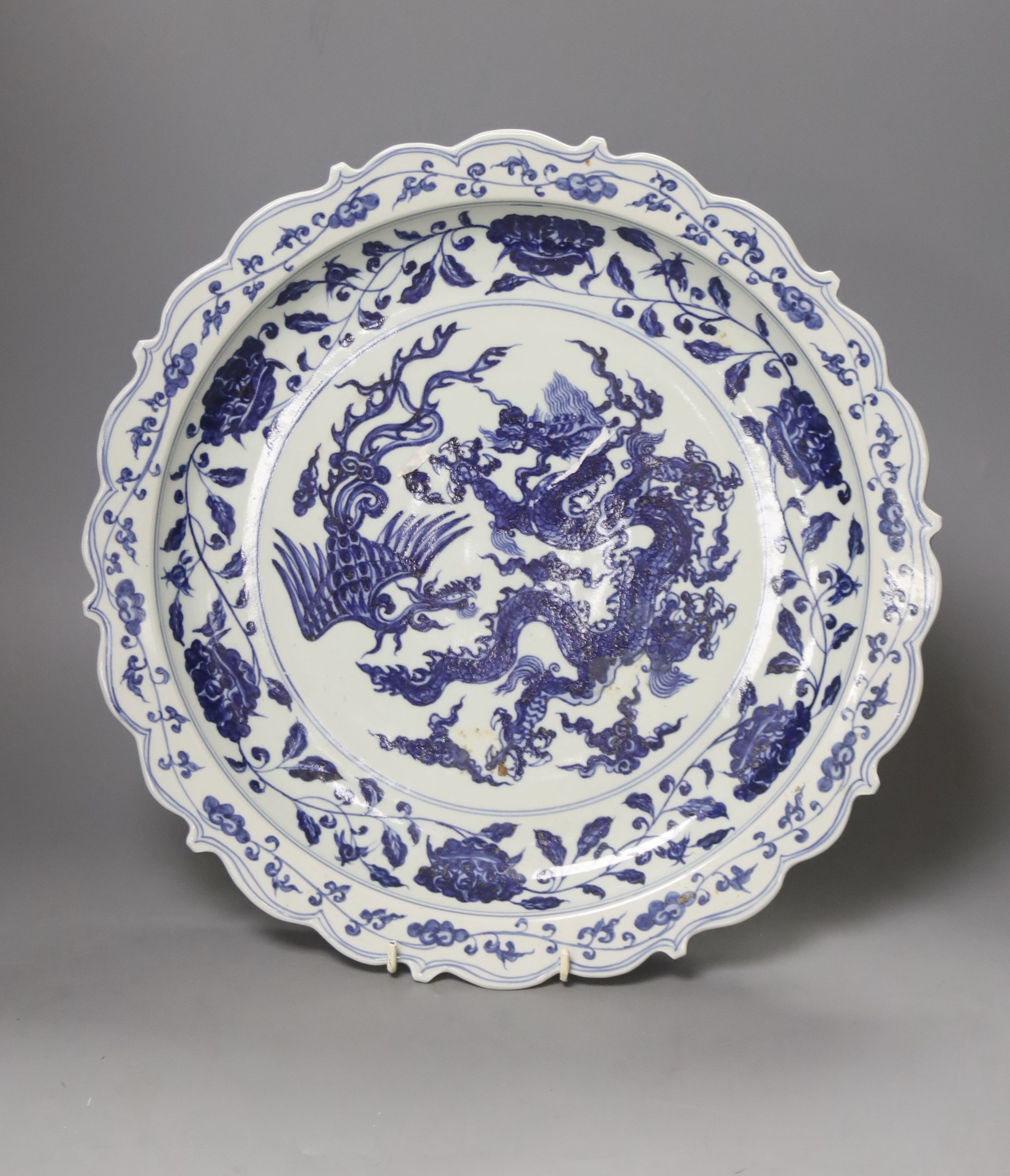 A Chinese blue and white Ming style dragon and phoenix dish, diameter 40cm